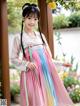 A young girl wearing a pink and blue hanbok.