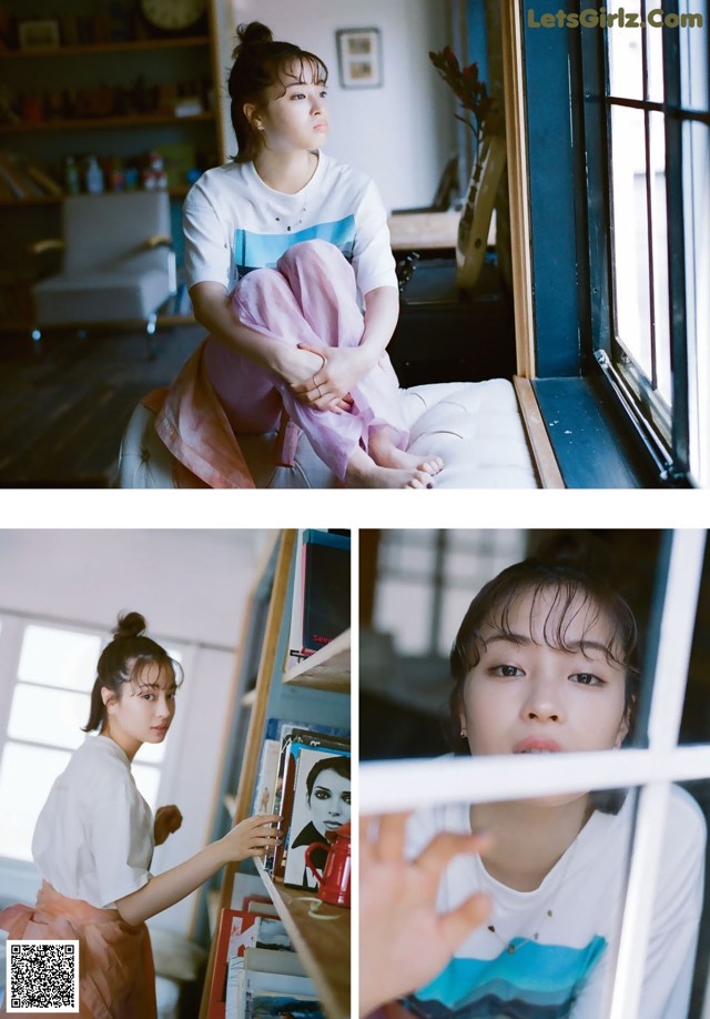 A woman sitting on a window sill looking out the window.