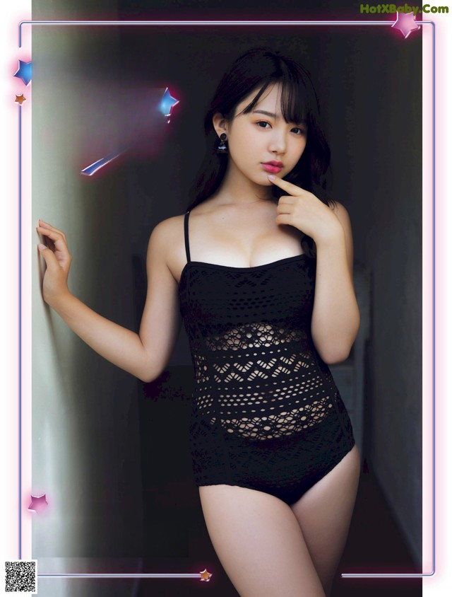 A woman in a black bathing suit posing for a magazine.