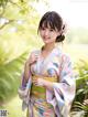 A woman in a kimono posing for a picture.