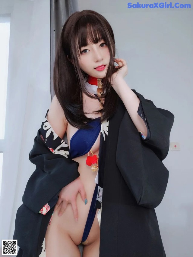A woman in a black kimono posing for the camera.