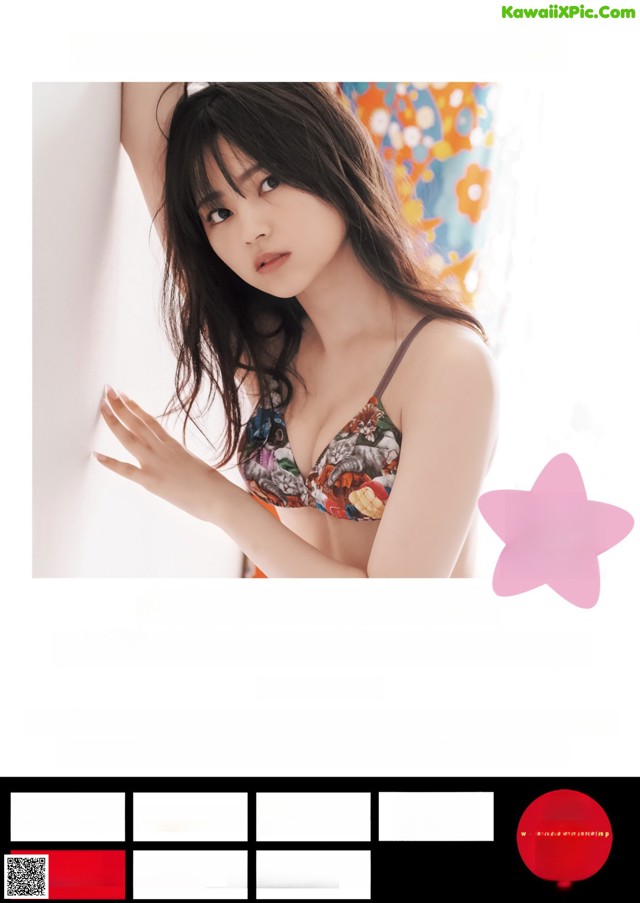 A woman in a bikini leaning against a wall.
